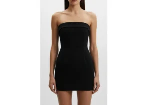 Woman wearing a black straight neckline strapless mini dress with clean horizontal bodice