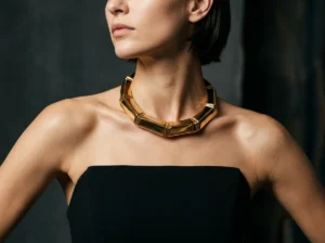 Bold collar necklace styled on a black straight strapless mini dress as a statement jewelry focal point